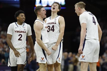 Dec 2, 2023; Charlottesville, Virginia, USA; Virginia Cavaliers guard Isaac McKneely (11) celebrates with teammates after a three point field goal against the Syracuse Orange during the first half at John Paul Jones Arena. Mandatory Credit: Geoff Burke-USA TODAY Sports