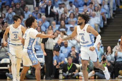 Dec 2, 2023; Chapel Hill, North Carolina, USA;  North Carolina Tar Heels guard Elliot Cadeau (2) reacts with guard RJ Davis (4) in the first half at Dean E. Smith Center. Mandatory Credit: Bob Donnan-USA TODAY Sports