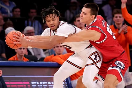 Dec 5, 2023; New York, New York, USA; Illinois Fighting Illini guard Terrence Shannon Jr. (0) is fouled by Florida Atlantic Owls center Vladislav Goldin (50) during the second half at Madison Square Garden. Mandatory Credit: Brad Penner-USA TODAY Sports