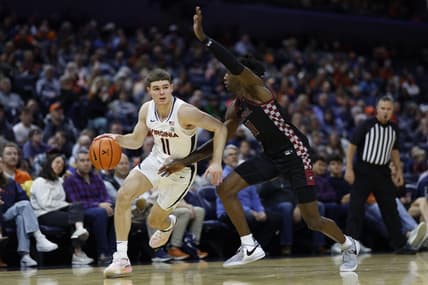 Dec 5, 2023; Charlottesville, Virginia, USA; Virginia Cavaliers guard Isaac McKneely (11) drives to the basket as North Carolina Central Eagles guard Keishon Porter (11) defends in the second half at John Paul Jones Arena. Mandatory Credit: Geoff Burke-USA TODAY Sports