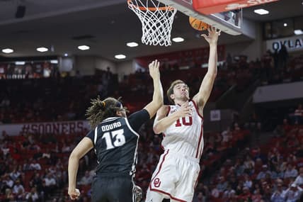Dec 5, 2023; Norman, Oklahoma, USA; Oklahoma Sooners forward Sam Godwin (10) shoots as Providence Friars forward Josh Oduro (13) defends during the second half at Lloyd Noble Center. Mandatory Credit: Alonzo Adams-USA TODAY Sports