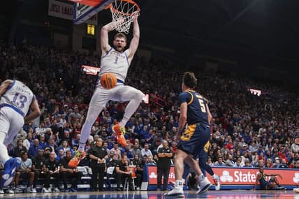 Dec 5, 2023; Lawrence, Kansas, USA; Kansas Jayhawks center Hunter Dickinson (1) dunks the ball as UMKC Kangaroos guard Jamar Brown (5) looks on during the first half at Allen Fieldhouse. Mandatory Credit: Denny Medley-USA TODAY Sports