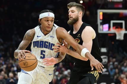 Dec 6, 2023; Cleveland, Ohio, USA; Orlando Magic forward Paolo Banchero (5) drives to the basket against Cleveland Cavaliers forward Dean Wade (32) during the first half at Rocket Mortgage FieldHouse. Mandatory Credit: Ken Blaze-USA TODAY Sports