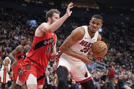 Dec 6, 2023; Toronto, Ontario, CAN; Miami Heat center Orlando Robinson (25) tries to around Toronto Raptors center Jakob Poeltl (19) during the first half at Scotiabank Arena. Mandatory Credit: John E. Sokolowski-USA TODAY Sports