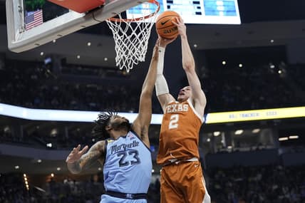 Dec 6, 2023; Milwaukee, Wisconsin, USA;  Texas Longhorns guard Chendall Weaver (2) shoots over Marquette Golden Eagles forward David Joplin (23) during the first half at Fiserv Forum. Mandatory Credit: Jeff Hanisch-USA TODAY Sports