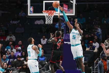Dec 8, 2023; Charlotte, North Carolina, USA; Charlotte Hornets center Mark Williams (5) blocks a shot by Toronto Raptors guard Dennis Schroder (17)  during the first quarter at the Spectrum Center. Mandatory Credit: Jim Dedmon-USA TODAY Sports