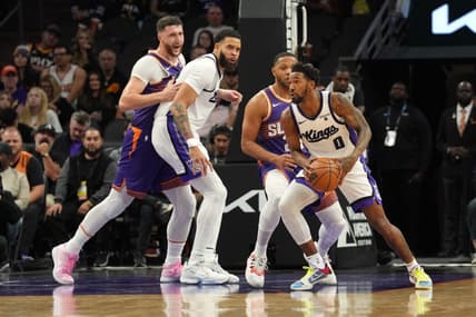 Dec 8, 2023; Phoenix, Arizona, USA; Sacramento Kings guard Malik Monk (0) controls the ball against the Phoenix Suns during the first half at Footprint Center. Mandatory Credit: Joe Camporeale-USA TODAY Sports