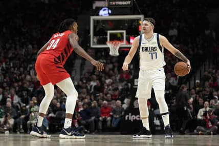 Dec 8, 2023; Portland, Oregon, USA; Dallas Mavericks point guard Luka Doncic (77) brings the ball up court against Portland Trail Blazers forward Jabari Walker (34) during the second half at Moda Center. Mandatory Credit: Soobum Im-USA TODAY Sports