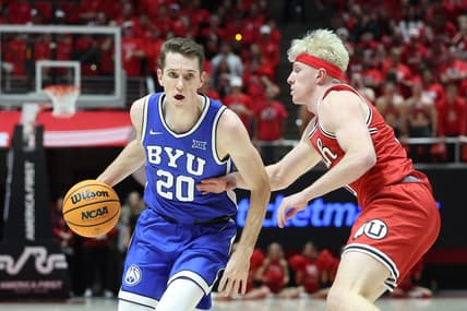Dec 9, 2023; Salt Lake City, Utah, USA; Brigham Young Cougars guard Spencer Johnson (20) drives against Utah Utes guard Hunter Erickson (0) during the first half at Jon M. Huntsman Center. Mandatory Credit: Rob Gray-USA TODAY Sports