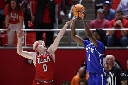 Dec 9, 2023; Salt Lake City, Utah, USA; Brigham Young Cougars guard Jaxson Robinson (2) is fouled by Utah Utes guard Hunter Erickson (0) shooting a three point shot during the second half at Jon M. Huntsman Center. Mandatory Credit: Rob Gray-USA TODAY Sports