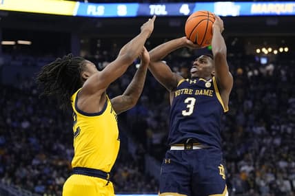 Dec 9, 2023; Milwaukee, Wisconsin, USA;  Notre Dame Fighting Irish guard Markus Burton (3) shoots against Marquette Golden Eagles guard Sean Jones (22) during the first half at Fiserv Forum. Mandatory Credit: Jeff Hanisch-USA TODAY Sports