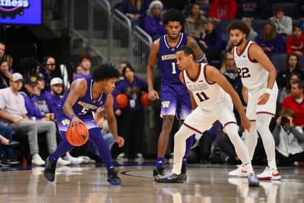 Dec 9, 2023; Seattle, Washington, USA; Gonzaga Bulldogs guard Nolan Hickman (11) guards Washington Huskies guard Sahvir Wheeler (5) during the second half at Alaska Airlines Arena at Hec Edmundson Pavilion. Mandatory Credit: Steven Bisig-USA TODAY Sports.