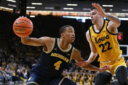 Dec 10, 2023; Iowa City, Iowa, USA; Michigan Wolverines guard Nimari Burnett (4) controls the ball as Iowa Hawkeyes forward Patrick McCaffery (22) defends during the first half at Carver-Hawkeye Arena. Mandatory Credit: Jeffrey Becker-USA TODAY Sports