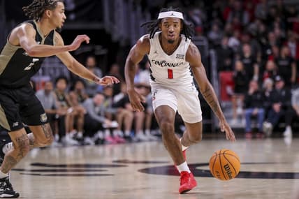 Dec 12, 2023; Cincinnati, Ohio, USA; Cincinnati Bearcats guard Day Day Thomas (1) dribbles against Bryant Bulldogs guard Tyler Brelsford (2) in the second half at Fifth Third Arena. Mandatory Credit: Katie Stratman-USA TODAY Sports
