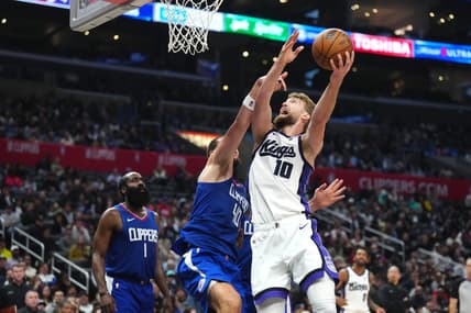Dec 6, 2023; Los Angeles, California, USA; Sacramento Kings forward Domantas Sabonis (10) shoots the ball against LA Clippers center Ivica Zubac (40) in the second half at Crypto.com Arena. Mandatory Credit: Kirby Lee-USA TODAY Sports