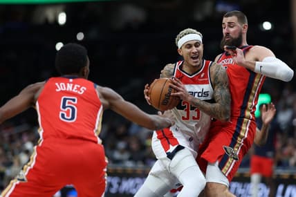 Dec 13, 2023; Washington, District of Columbia, USA; Washington Wizards forward Kyle Kuzma (33) drives to the basket as New Orleans Pelicans center Jonas Valanciunas (17) defends in the second quarter at Capital One Arena. Mandatory Credit: Geoff Burke-USA TODAY Sports
