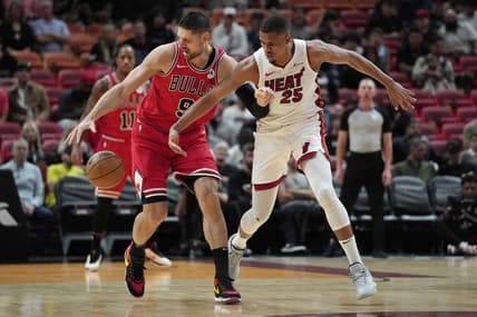 Dec 14, 2023; Miami, Florida, USA; Chicago Bulls center Nikola Vucevic (9) intercepts a pass intended for Miami Heat center Orlando Robinson (25) during the first half at Kaseya Center. Mandatory Credit: Jim Rassol-USA TODAY Sports