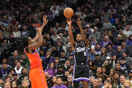 Dec 14, 2023; Sacramento, California, USA; Sacramento Kings guard Malik Monk (0) shoots against Oklahoma City Thunder guard Cason Wallace (left) during the second quarter at Golden 1 Center. Mandatory Credit: Darren Yamashita-USA TODAY Sports
