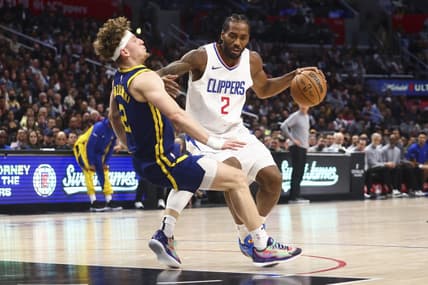Dec 14, 2023; Los Angeles, California, USA; LA Clippers forward Kawhi Leonard (2) dribbles against Golden State Warriors guard Brandin Podziemski (2) and draws an offensive foul during the second half of the game at Crypto.com Arena. Mandatory Credit: Jessica Alcheh-USA TODAY Sports
