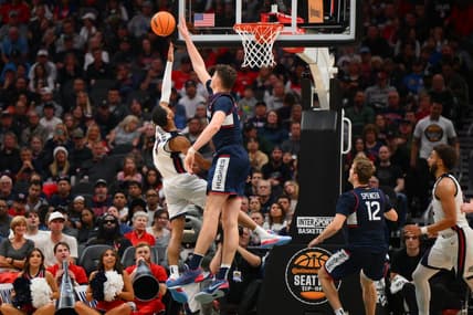 Dec 15, 2023; Seattle, Washington, USA; Connecticut Huskies center Donovan Clingan (32) blocks the shot attempt by Gonzaga Bulldogs guard Nolan Hickman (11) during the second half at Climate Pledge Arena. Mandatory Credit: Steven Bisig-USA TODAY Sports