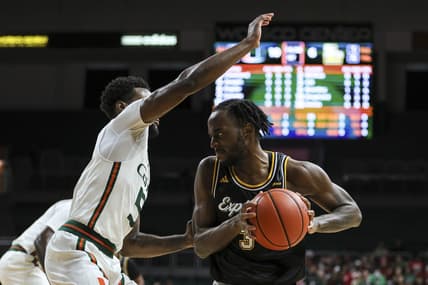 Dec 16, 2023; Coral Gables, Florida, USA; La Salle Explorers guard Anwar Gill (3) protects the basketball from Miami Hurricanes guard Wooga Poplar (5) during the first half at Watsco Center. Mandatory Credit: Sam Navarro-USA TODAY Sports