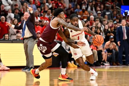 Dec 16, 2023; Houston, Texas, USA; Houston Cougars guard Jamal Shead (1) drives to the basket as Texas A&M Aggies guard Wade Taylor IV (4) defends during the second half at Toyota Center. Mandatory Credit: Maria Lysaker-USA TODAY Sports