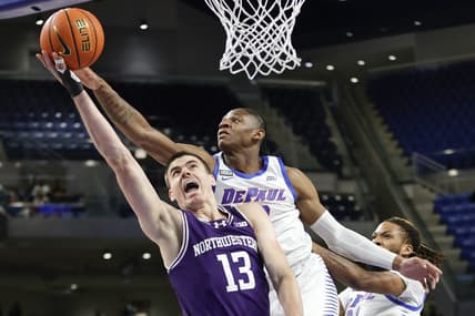 Dec 16, 2023; Chicago, Illinois, USA; Northwestern Wildcats guard Brooks Barnhizer (13) goes to the basket against DePaul Blue Demons guard Elijah Fisher (22) during the first half at Wintrust Arena. Mandatory Credit: Kamil Krzaczynski-USA TODAY Sports
