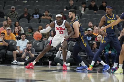 Dec 16, 2023; San Antonio, Texas, USA;  Mississippi Rebels forward Moussa Cisse (33) is defended by California Golden Bears forward Fardaws Aimaq in the first half at the Frost Bank Center. Mandatory Credit: Daniel Dunn-USA TODAY Sports