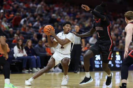 Dec 16, 2023; Charlottesville, Virginia, USA; Virginia Cavaliers guard Reece Beekman (2) holds the ball as Northeastern Huskies guard Masai Troutman (1) defends in the second half at John Paul Jones Arena. Mandatory Credit: Geoff Burke-USA TODAY Sports
