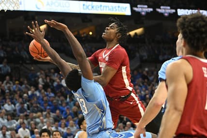 Dec 16, 2023; Omaha, Nebraska, USA; Alabama Crimson Tide forward Nick Pringle (23) drives against Creighton Bluejays center Fredrick King (33) in the first half  at CHI Health Center Omaha. Mandatory Credit: Steven Branscombe-USA TODAY Sports