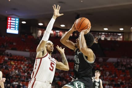 Dec 16, 2023; Norman, Oklahoma, USA; Green Bay Phoenix guard Noah Reynolds (21) shoots against Oklahoma Sooners guard Rivaldo Soares (5) during the first half at Lloyd Noble Center. Mandatory Credit: Alonzo Adams-USA TODAY Sports