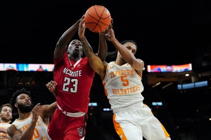 Dec 16, 2023; San Antonio, Texas, USA;  North Carolina State Wolfpack forward Mohamed Diarra (23) and Tennessee Volunteers guard Zakai Zeigler (5) go after the ball in the first half at the Frost Bank Center. Mandatory Credit: Daniel Dunn-USA TODAY Sports