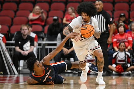 Dec 17, 2023; Louisville, Kentucky, USA;  Louisville Cardinals guard Skyy Clark (55) dribbles against Pepperdine Waves guard Michael Ajayi (1) during the second half at KFC Yum! Center. Louisville defeated Pepperdine 85-63. Mandatory Credit: Jamie Rhodes-USA TODAY Sports