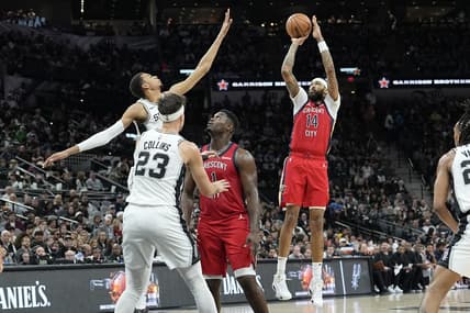 Dec 17, 2023; San Antonio, Texas, USA; New Orleans Pelicans Brandon Ingram (14) shoots over San Antonio Spurs forward Victor Wembanyama (1) during the first half at Frost Bank Center. Mandatory Credit: Scott Wachter-USA TODAY Sports