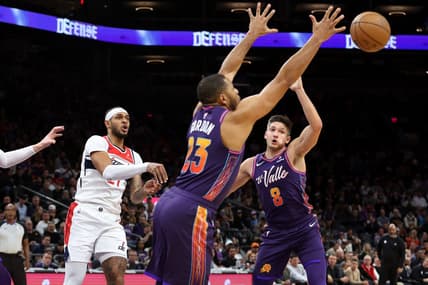 Dec 17, 2023; Phoenix, Arizona, USA; Phoenix Suns guard Eric Gordon (23) gets a steel from Washington Wizards center Daniel Gafford (21) during the first quarter at Footprint Center. Mandatory Credit: Zachary BonDurant-USA TODAY Sports
