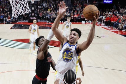 Dec 17, 2023; Portland, Oregon, USA; Golden State Warriors forward Trayce Jackson-Davis (32) shoots the ball over Portland Trail Blazers center Deandre Anton (2, left) during the second half at Moda Center. Mandatory Credit: Soobum Im-USA TODAY Sports