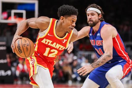 Dec 18, 2023; Atlanta, Georgia, USA; Atlanta Hawks forward De'Andre Hunter (12) drives on Detroit Pistons forward Joe Harris (31) in the second quarter at State Farm Arena. Mandatory Credit: Brett Davis-USA TODAY Sports