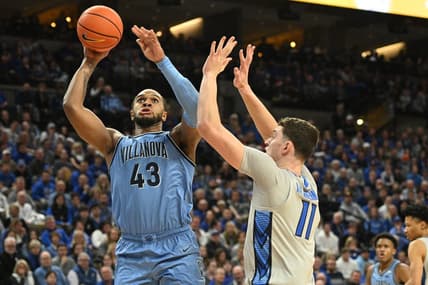 Dec 20, 2023; Omaha, Nebraska, USA;  Villanova Wildcats forward Eric Dixon (43) scores against Creighton Bluejays center Ryan Kalkbrenner (11) in the first half at CHI Health Center Omaha. Mandatory Credit: Steven Branscombe-USA TODAY Sports