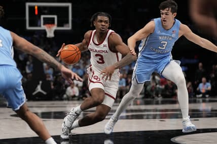 Dec 20, 2023; Charlotte, North Carolina, USA; Oklahoma Sooners guard Otega Oweh (3) drives to the basket against North Carolina Tar Heels guard Cormac Ryan (3) during the first half at Spectrum Center. Mandatory Credit: Jim Dedmon-USA TODAY Sports