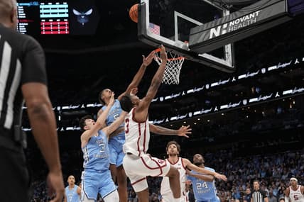 Dec 20, 2023; Charlotte, North Carolina, USA; Oklahoma Sooners guard Otega Oweh (3) has his shot blocked by North Carolina Tar Heels forward Armando Bacot (5) during the first half at Spectrum Center. Mandatory Credit: Jim Dedmon-USA TODAY Sports