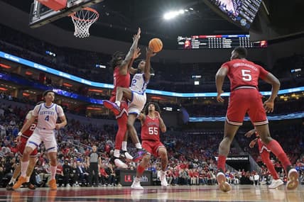 Dec 21, 2023; Louisville, Kentucky, USA;  Kentucky Wildcats guard Antonio Reeves (12) shoots against Louisville Cardinals guard Mike James (0) during the first half at KFC Yum! Center. Mandatory Credit: Jamie Rhodes-USA TODAY Sports
