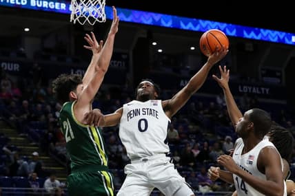 Dec 21, 2023; University Park, Pennsylvania, USA; Penn State Nittany Lions guard Kanye Clary (0) drives the ball to the basket as Le Moyne Dolphins guard Trent Mosquera (21) defends during the first half at Bryce Jordan Center. Mandatory Credit: Matthew O'Haren-USA TODAY Sports