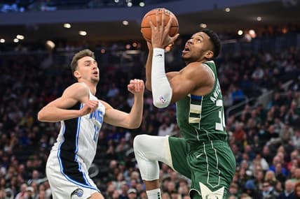 Dec 21, 2023; Milwaukee, Wisconsin, USA; Milwaukee Bucks forward Giannis Antetokounmpo (34) takes a shot against Orlando Magic forward Franz Wagner (22) in the first quarter at Fiserv Forum. Mandatory Credit: Benny Sieu-USA TODAY Sports