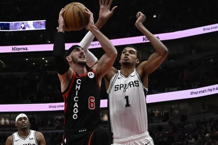 Dec 21, 2023; Chicago, Illinois, USA;  Chicago Bulls guard Alex Caruso (6) shoots against San Antonio Spurs center Victor Wembanyama (1) during the first half at the United Center. Mandatory Credit: Matt Marton-USA TODAY Sports