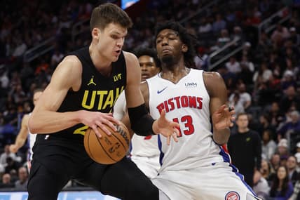Dec 21, 2023; Detroit, Michigan, USA;  Utah Jazz center Walker Kessler (24) is defended by Detroit Pistons center James Wiseman (13) in the second half at Little Caesars Arena. Mandatory Credit: Rick Osentoski-USA TODAY Sports