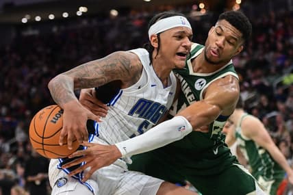 Dec 21, 2023; Milwaukee, Wisconsin, USA; Milwaukee Bucks forward Giannis Antetokounmpo (34) tries to steal the ball from Orlando Magic forward Paolo Banchero (5) in the third quarter at Fiserv Forum. Mandatory Credit: Benny Sieu-USA TODAY Sports