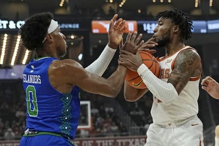 Dec 22, 2023; Austin, Texas, USA; Texas Longhorns guard Tyrese Hunter (4) and Texas A&M Corpus Christi guard Chris Johnson (0) battle for the loose ball during the first half at Moody Center. Mandatory Credit: Scott Wachter-USA TODAY Sports