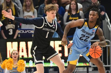 Dec 22, 2023; Milwaukee, Wisconsin, USA; Marquette Golden Eagles guard Sean Jones (22) is guarded by Georgetown Hoyas guard Rowan Brumbaugh (1) in the first half at Fiserv Forum. Mandatory Credit: Benny Sieu-USA TODAY Sports