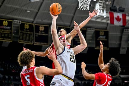 Dec 22, 2023; South Bend, Indiana, USA; Notre Dame Fighting Irish forward Matt Zona (25) goes up for a shot as Marist Red Foxes forward Jaden Daughtry (11) prepares to block in the first half at the Purcell Pavilion. Mandatory Credit: Matt Cashore-USA TODAY Sports