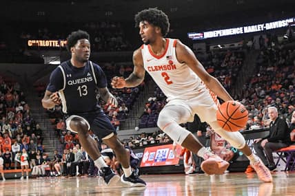 Dec 22, 2023; Clemson, South Carolina, USA; Clemson sophomore guard Dillon Hunter (2) dribbles near Queens University guard Dayton Albury (13) during the second half at Littlejohn Coliseum. Mandatory Credit: Ken Ruinard-USA TODAY Sports